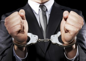 Businessman hand cuffed (mid section)