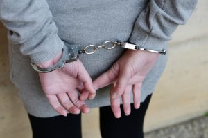 Woman in handcuffs behind her back